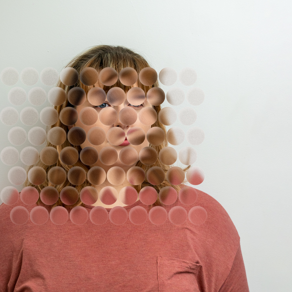 A portrait of a woman with glass circles obscuring her face